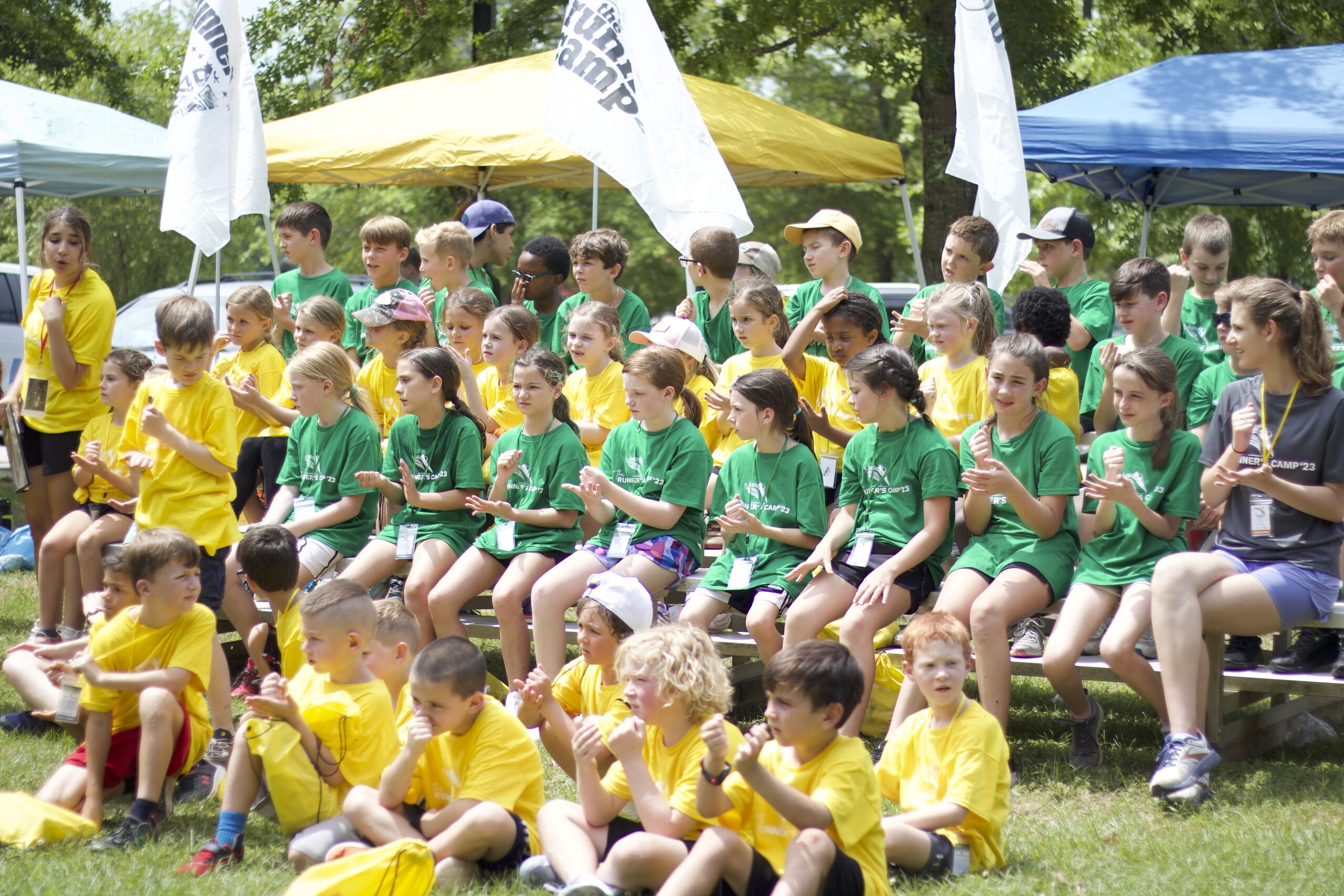 The camp teams gathered together in their colored shirts at the opening program